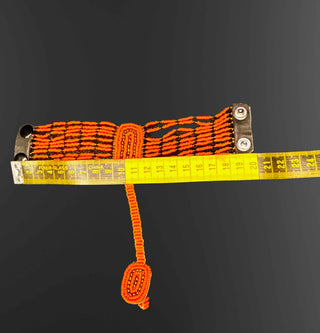 Orange webbing strap with metal clasps on a black background