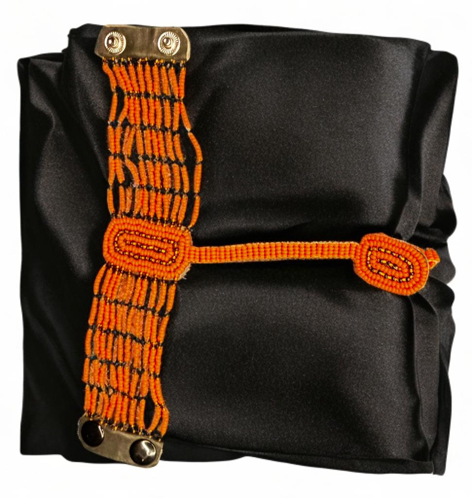 Black bag with orange strap featuring metal clasps on a white background