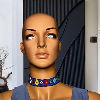 Mannequin head wearing a colorful beaded choker with a neutral background
