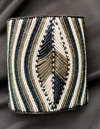 Beaded clutch with geometric pattern on a dark background